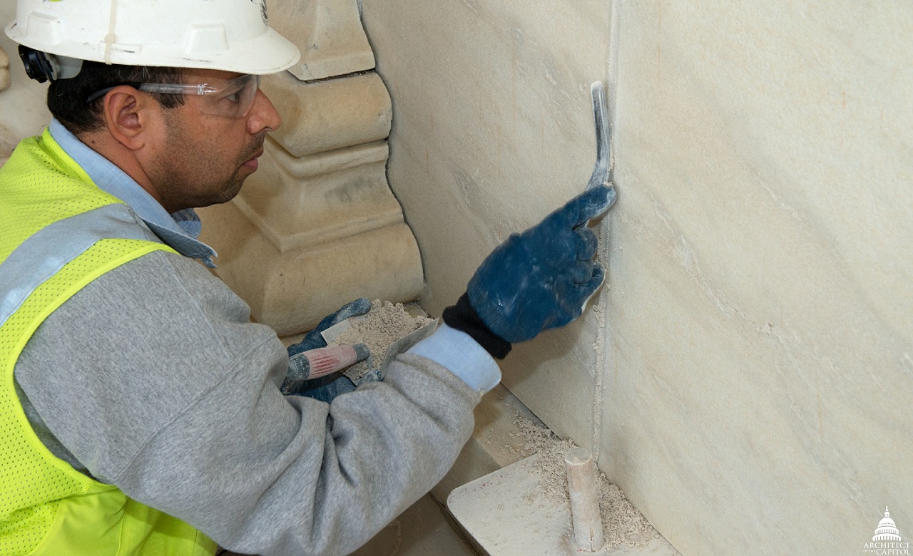 worker repairing the wall