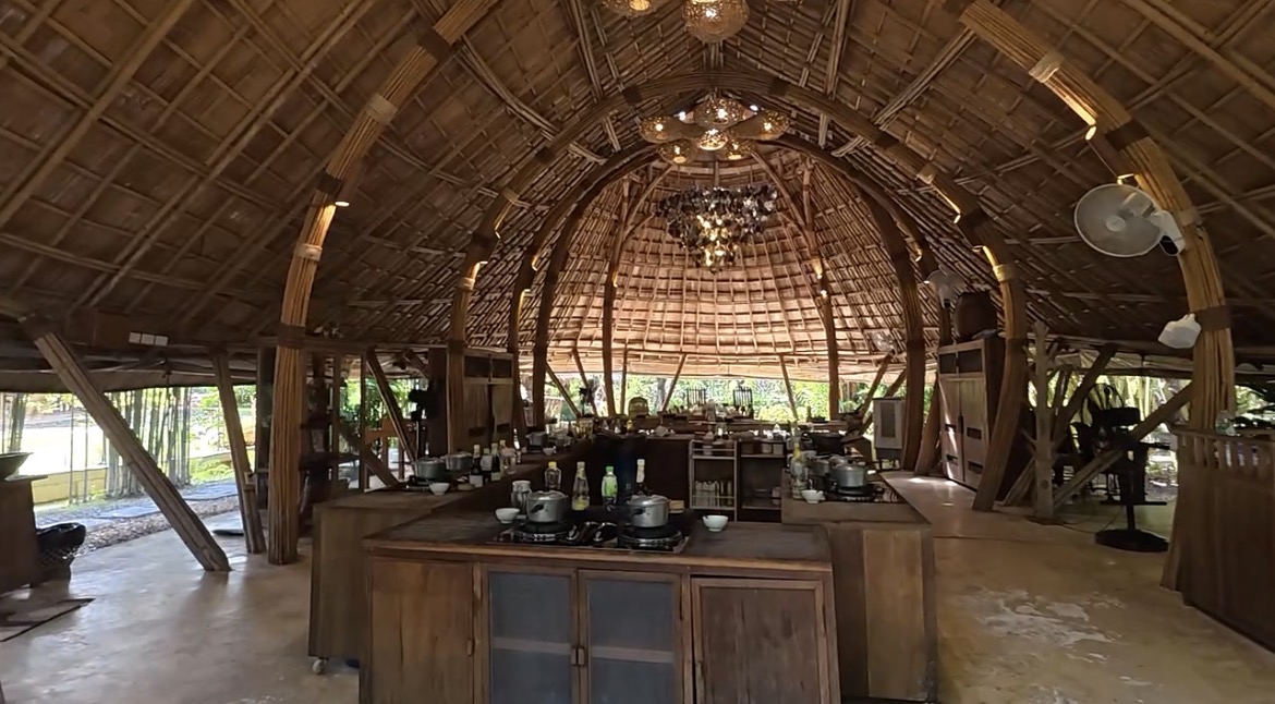 Guests taking part in a Thai cooking class as part of a hostel travel experience in Thailand.