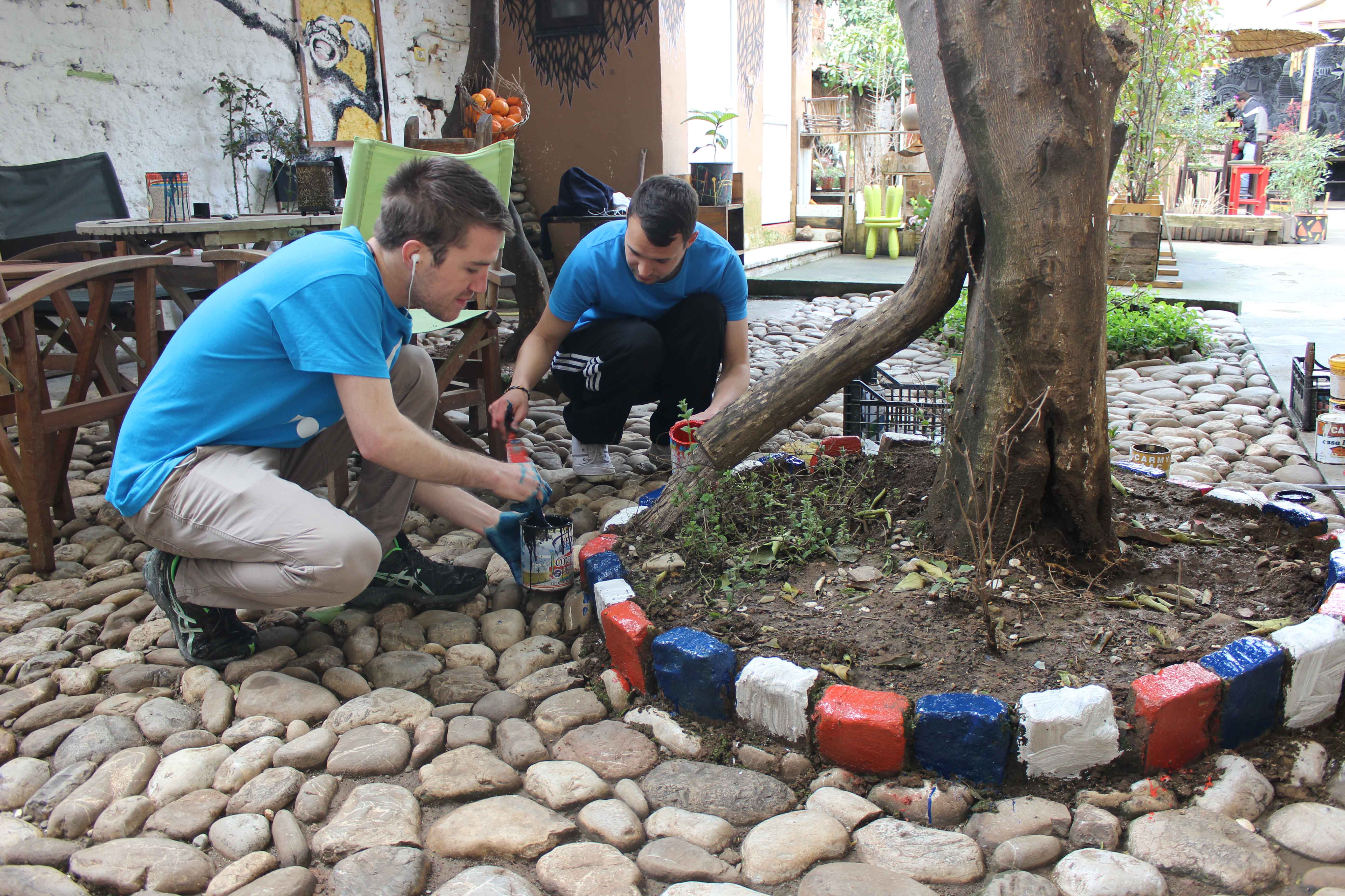 Two hostel volunteers paining outside