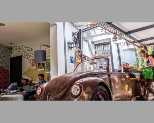 Selina Hostel reception with VW Bug as desk