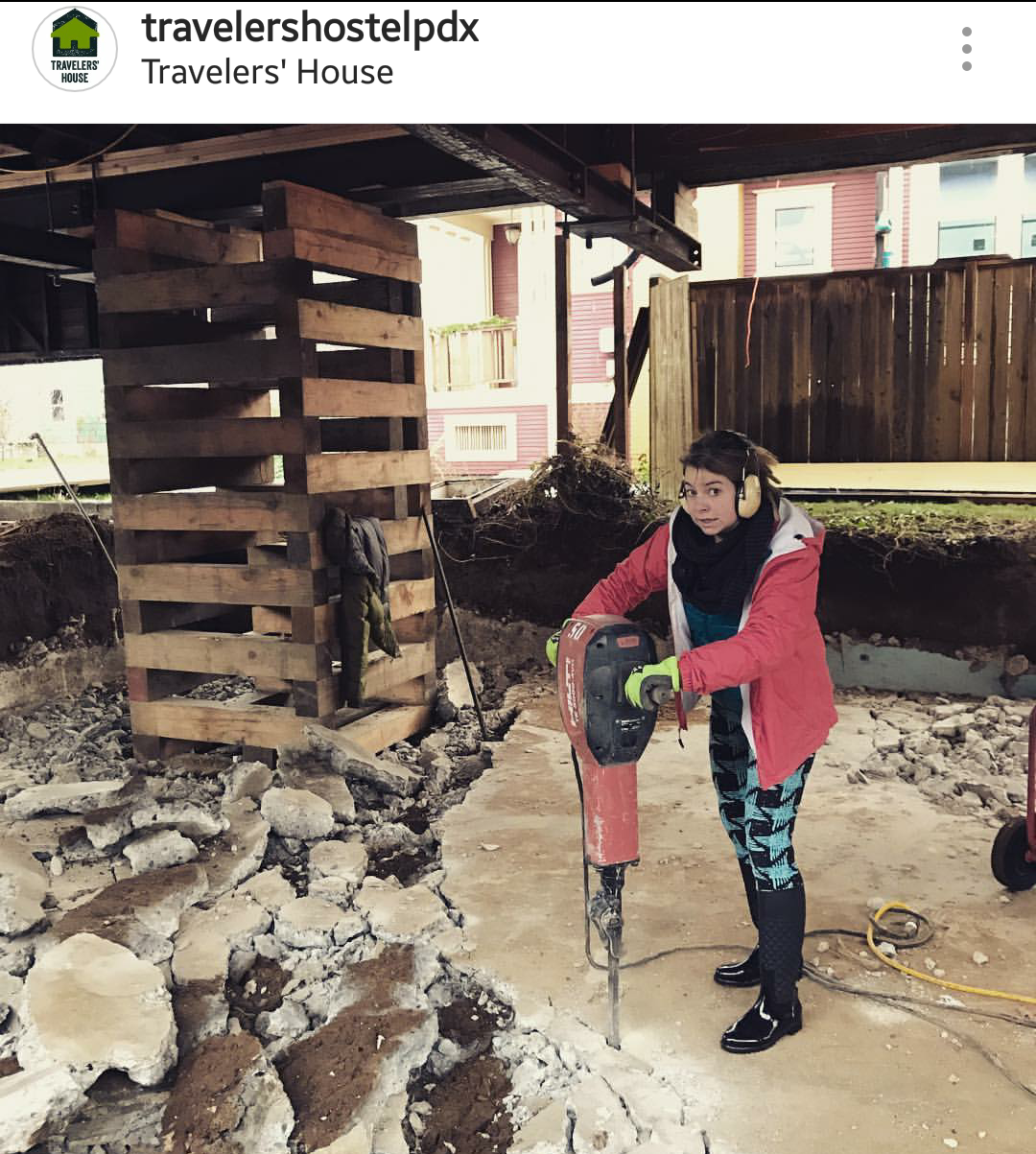 Picture of a girl using a heavy jackhammer