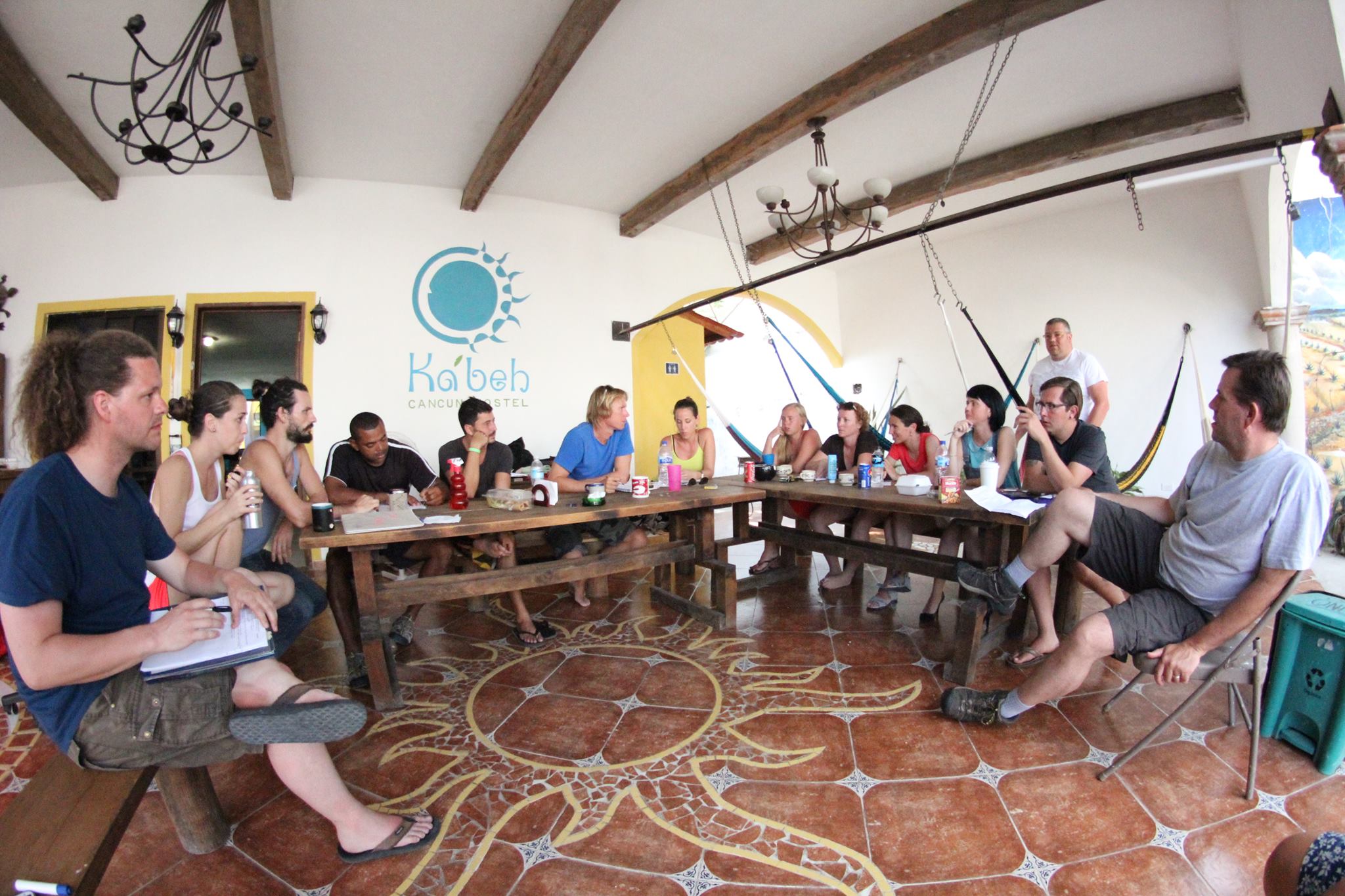 people sitting at a table in cancun discussing the hostel industry
