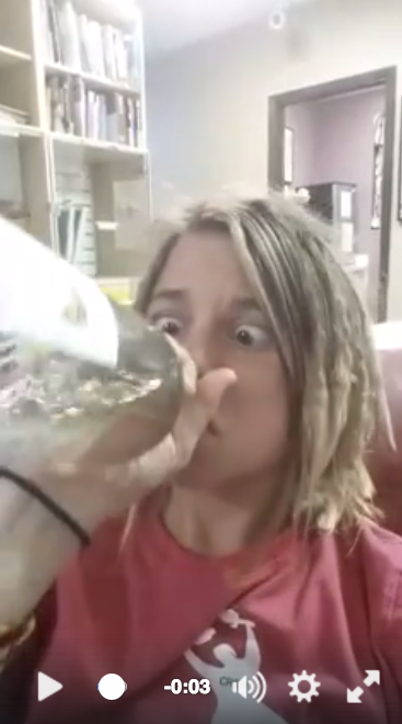 Girl drinking a bottle of wine and going cross eyed