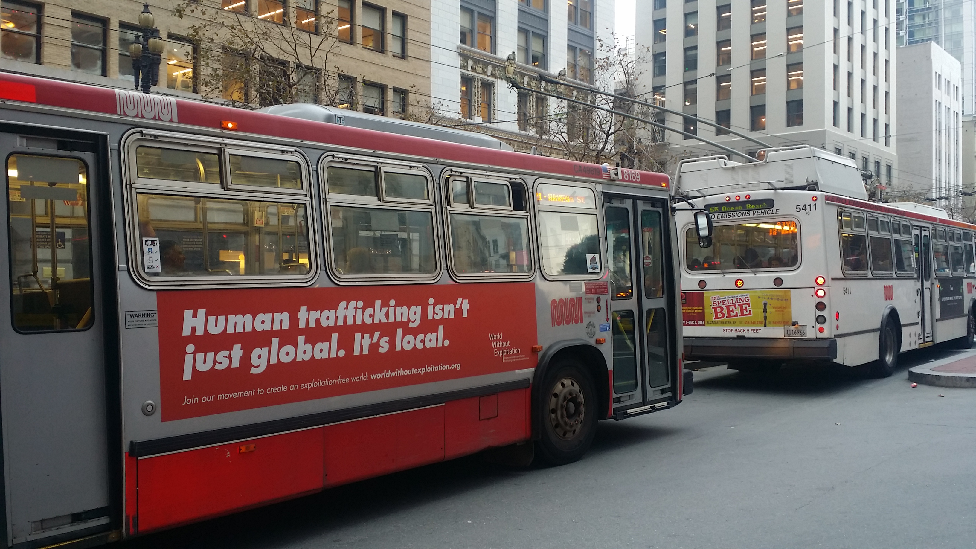 A photo of an SF MUNI bus with human trafficking sign