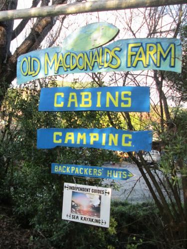 indepent guide sign entrance to old macdonalds farm camping backpacker huts bush
