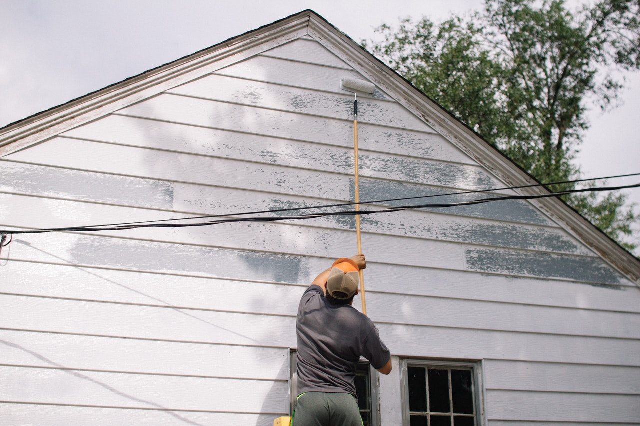 man painting exterior wall