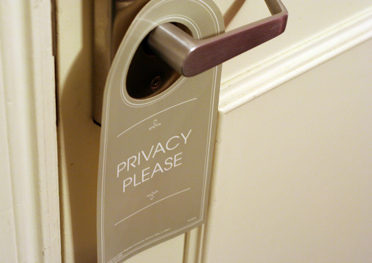 A privacy door tag hanging from a hostel room