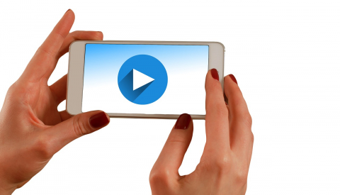 Video with a smartphone can be quick and easy Hands holding a smartphone showing video
