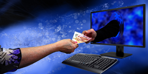 Crowdfunding can bring investment money from around the world, straight to you Arm reaching through the computer for money