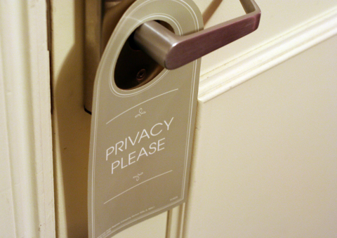 The Rise of Private Rooms in Hostels A privacy door tag hanging from a hostel room