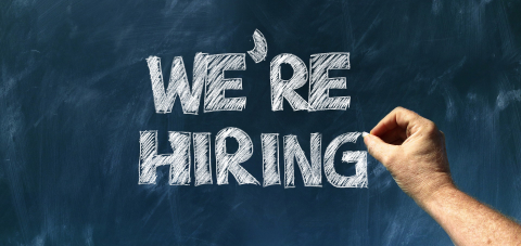 Where do you find your best managers? chalkboard sign with words we're hiring and hand writing the words